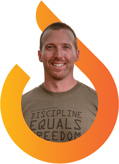 Smiling man with short hair and beard wearing a "Discipline Equals Freedom" t-shirt, framed by an orange, flame-shaped graphic.